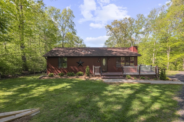 27 Honey Hill Rd, East Haddam, CT 06423 - back of property featuring a lawn, a chimney, and a wooden deck
