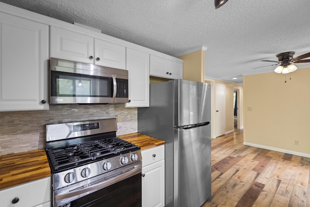 27 Honey Hill Rd, East Haddam, CT 06423 - kitchen featuring appliances with stainless steel finishes, butcher block counters, white cabinetry, and a textured ceiling