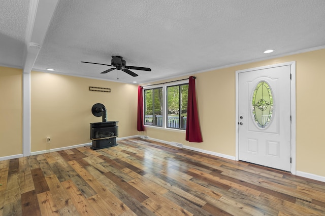 27 Honey Hill Rd, East Haddam, CT 06423 - foyer featuring a textured ceiling, a wood stove, a ceiling fan, hardwood / wood-style floors, and baseboards