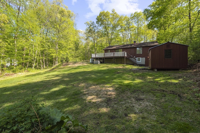 27 Honey Hill Rd, East Haddam, CT 06423 - view of green lawn with stairway, a wooden deck, an outbuilding, and a storage shed