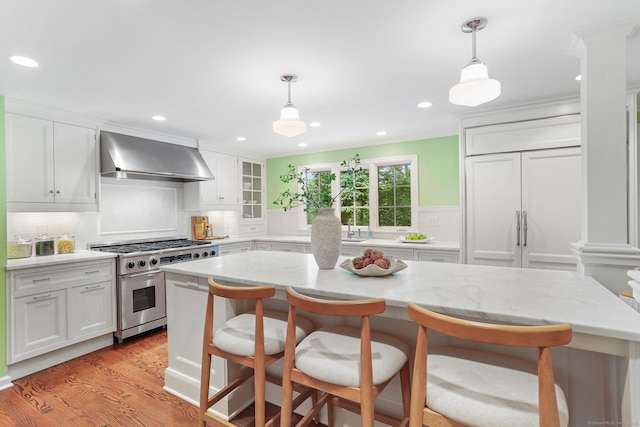 41 Little Brook Rd, Wilton, CT 06897 - kitchen featuring high end stove, wall chimney exhaust hood, white cabinets, recessed lighting, and ornamental molding