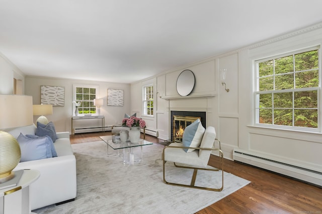 41 Little Brook Rd, Wilton, CT 06897 - living room with a baseboard heating unit, wood finished floors, a fireplace with flush hearth, and a decorative wall