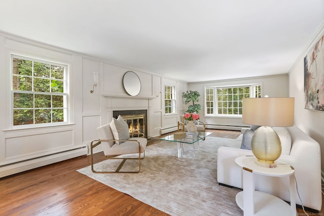 41 Little Brook Rd, Wilton, CT 06897 - living area featuring baseboard heating, wood finished floors, a fireplace with flush hearth, crown molding, and a baseboard heating unit