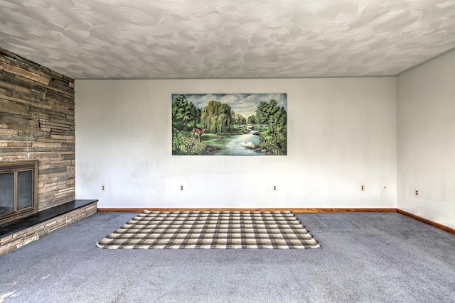 23 Pinesbridge Rd, Oxford, CT 06478 - unfurnished living room featuring carpet flooring, a stone fireplace, baseboards, and a textured ceiling