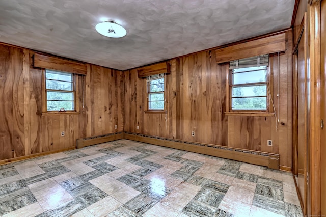 23 Pinesbridge Rd, Oxford, CT 06478 - unfurnished room with plenty of natural light, tile patterned floors, wooden walls, and baseboard heating