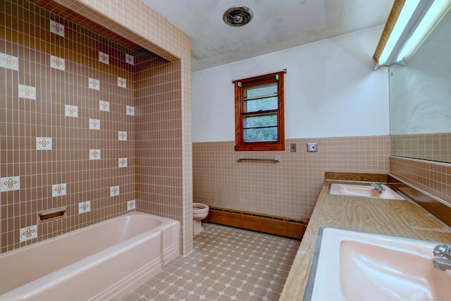 23 Pinesbridge Rd, Oxford, CT 06478 - bathroom featuring tile walls, a baseboard radiator, toilet, a tub, and a wainscoted wall