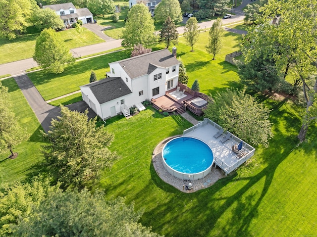 aerial view of property and surrounding area with a pool area