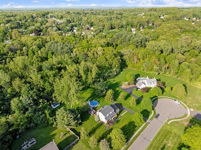 aerial view of property's location with a heavily wooded area