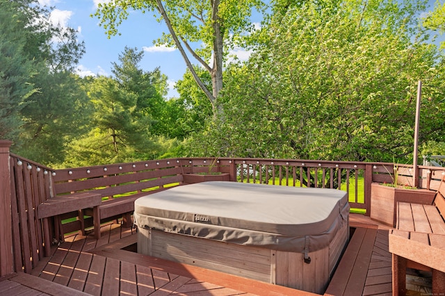 deck featuring a covered hot tub