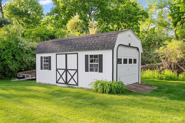 detached garage with view of scattered trees and a storage shed