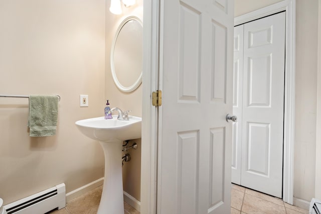 bathroom with a baseboard radiator, tile patterned flooring, and baseboards