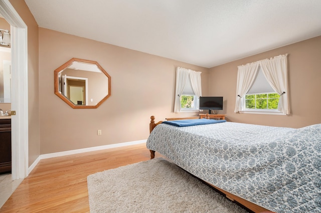 bedroom with wood finished floors and baseboards