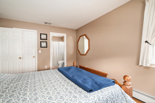bedroom featuring baseboard heating and connected bathroom