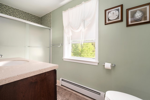 bathroom featuring baseboard heating, toilet, vanity, baseboards, and a shower with shower door