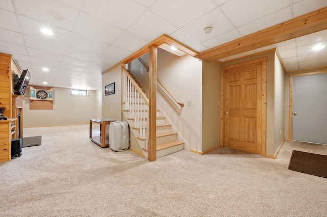 basement with stairs, carpet floors, baseboards, recessed lighting, and a paneled ceiling
