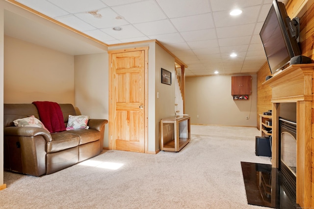 living area with carpet flooring, a drop ceiling, recessed lighting, and baseboards