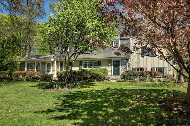 view of front facade featuring a front yard and board and batten siding