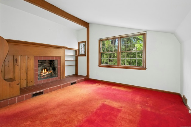 unfurnished living room with vaulted ceiling, a fireplace, carpet floors, and baseboards