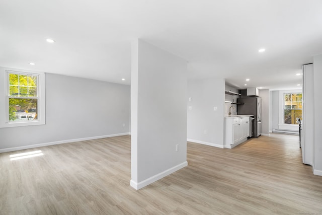 35 S St, Bethel, CT 06801 - unfurnished living room featuring a sink, plenty of natural light, light wood-type flooring, baseboards, and recessed lighting