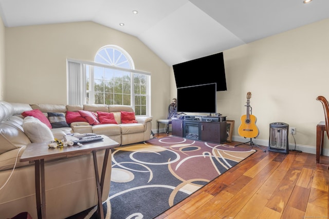 living area with lofted ceiling, hardwood / wood-style floors, recessed lighting, and baseboards