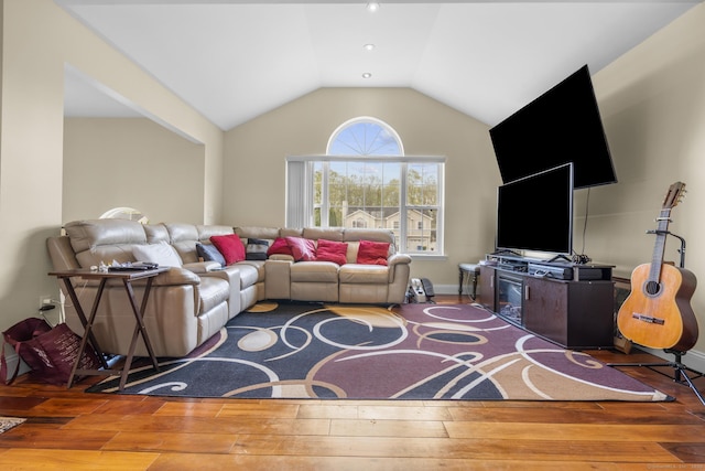 living area with wood-type flooring and vaulted ceiling