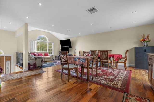 dining room featuring hardwood / wood-style flooring, visible vents, recessed lighting, vaulted ceiling, and baseboards