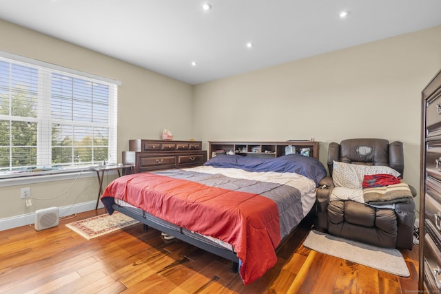 bedroom featuring baseboards, recessed lighting, and wood finished floors