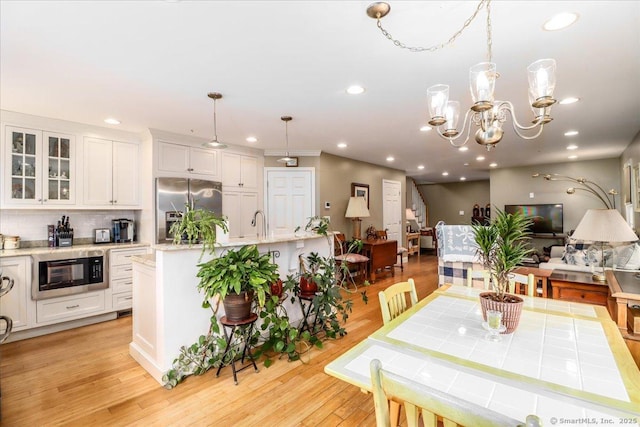 37A/K/A27 Oregon Ave, East Haven, CT 06512 - kitchen with stainless steel fridge, black microwave, recessed lighting, white cabinetry, and glass insert cabinets
