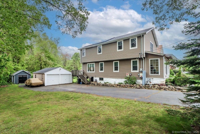 37A/K/A27 Oregon Ave, East Haven, CT 06512 - back of property with an outbuilding, a detached garage, and a yard