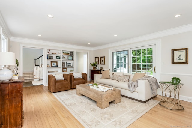 living area featuring light wood-style floors, stairway, ornamental molding, recessed lighting, and baseboards