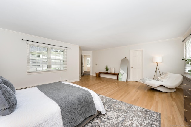 bedroom with light wood-style flooring, crown molding, and arched walkways