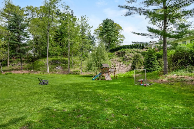 view of grassy yard featuring a playground