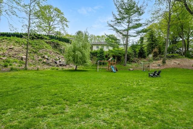 view of green lawn with a playground