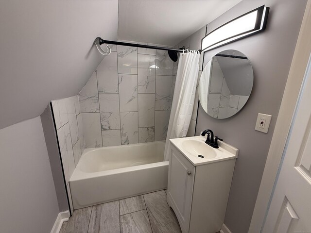 bathroom with shower / bath combo with shower curtain, marble finish flooring, vanity, and baseboards