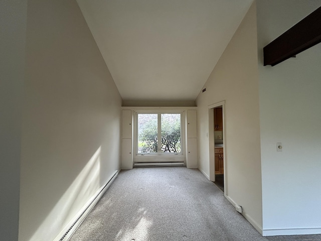 spare room with light colored carpet, baseboards, baseboard heating, and a baseboard heating unit