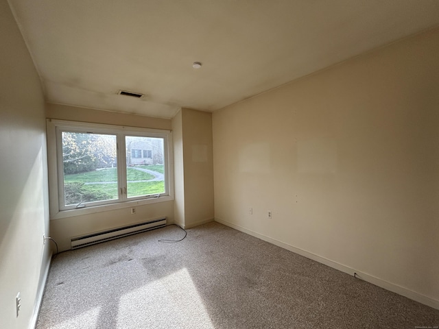 carpeted empty room featuring visible vents, baseboards, and a baseboard heating unit