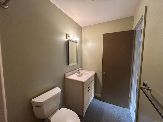 bathroom featuring toilet and vanity