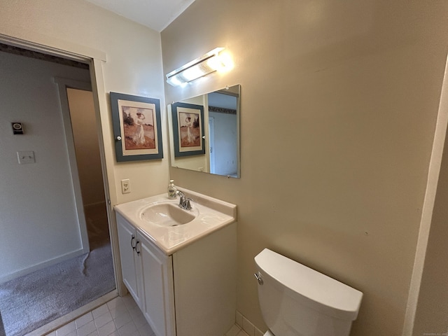 bathroom featuring toilet, tile patterned floors, and vanity