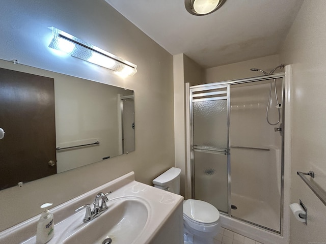 bathroom with a stall shower, tile patterned flooring, vanity, and toilet