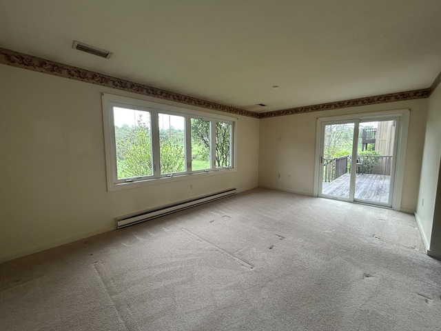8 Pilgrim Hbr Unit A, Wallingford, CT 06492 - empty room featuring a baseboard heating unit, light colored carpet, and baseboards