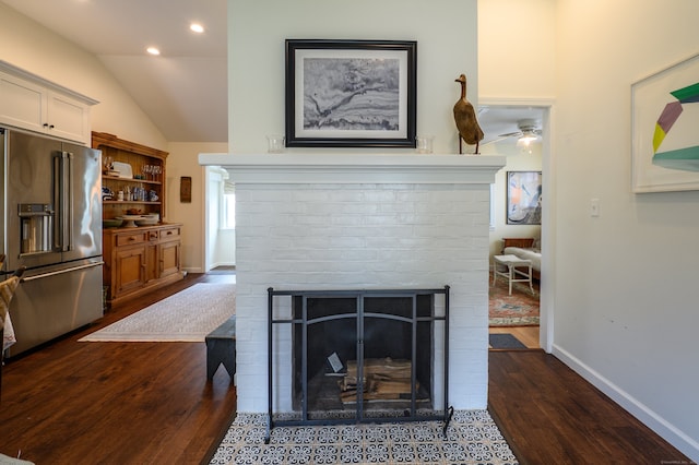 3 Clark Ave, Old Saybrook, CT 06475 - detailed view of high end fridge, a fireplace, dark wood finished floors, baseboards, and a ceiling fan