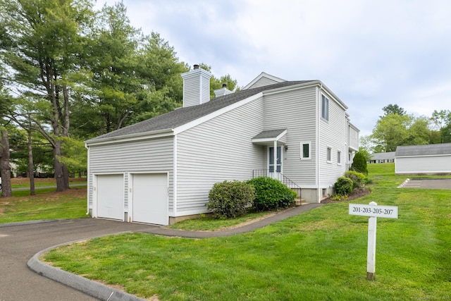 201 Greens Farm Rd Unit 201, Branford, CT 06405 - view of side of home with a chimney, a yard, roof with shingles, and asphalt driveway