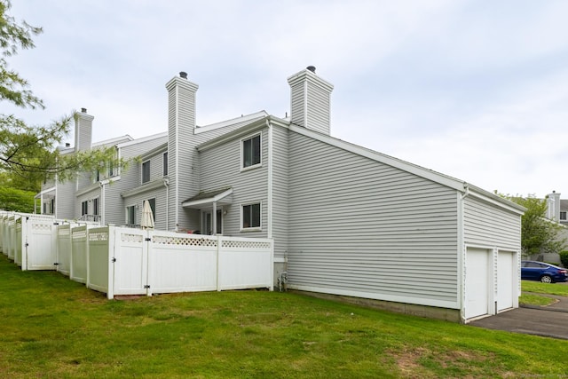 201 Greens Farm Rd Unit 201, Branford, CT 06405 - back of property featuring a gate, driveway, and a chimney