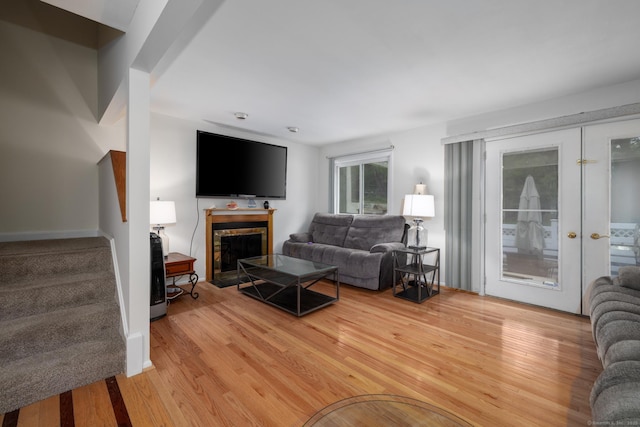 201 Greens Farm Rd Unit 201, Branford, CT 06405 - living room featuring light wood finished floors, a fireplace with flush hearth, and stairway