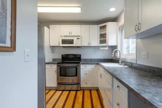 201 Greens Farm Rd Unit 201, Branford, CT 06405 - kitchen featuring stainless steel appliances, a sink, dark countertops, white cabinetry, and recessed lighting