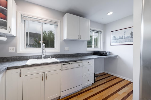 201 Greens Farm Rd Unit 201, Branford, CT 06405 - kitchen with a sink, dishwasher, white cabinetry, light wood finished floors, and dark countertops