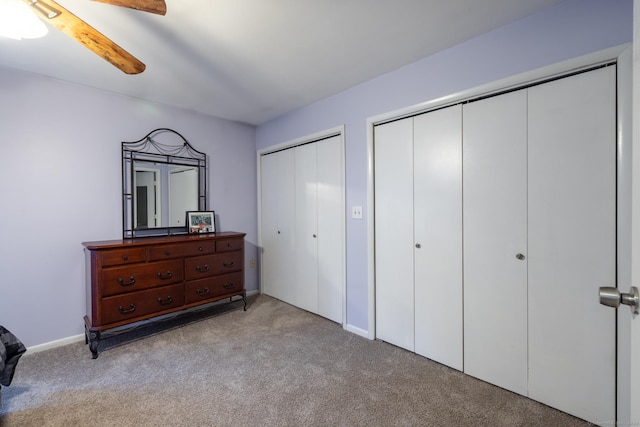 201 Greens Farm Rd Unit 201, Branford, CT 06405 - bedroom with light carpet, multiple closets, ceiling fan, and baseboards