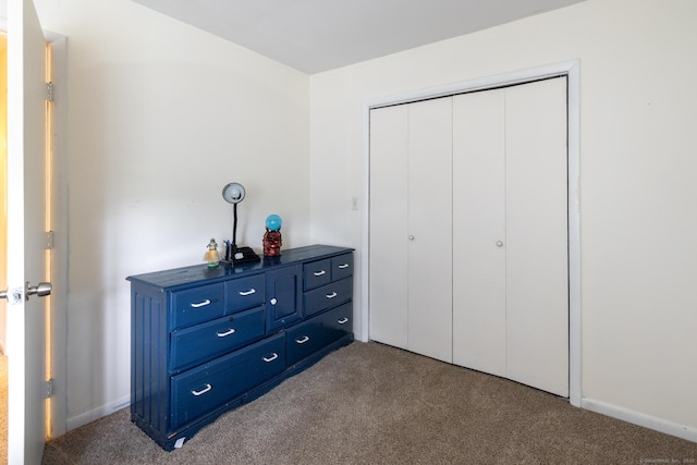 201 Greens Farm Rd Unit 201, Branford, CT 06405 - bedroom featuring dark carpet, a closet, and baseboards