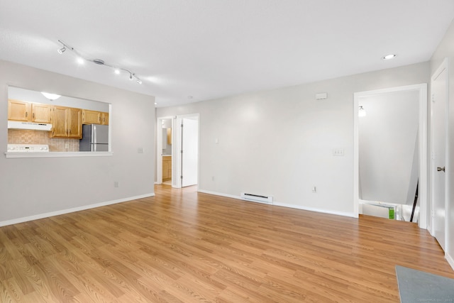 unfurnished living room featuring light wood-type flooring, baseboards, and baseboard heating