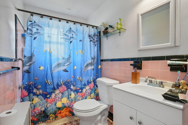 bathroom featuring curtained shower, tile walls, toilet, and vanity